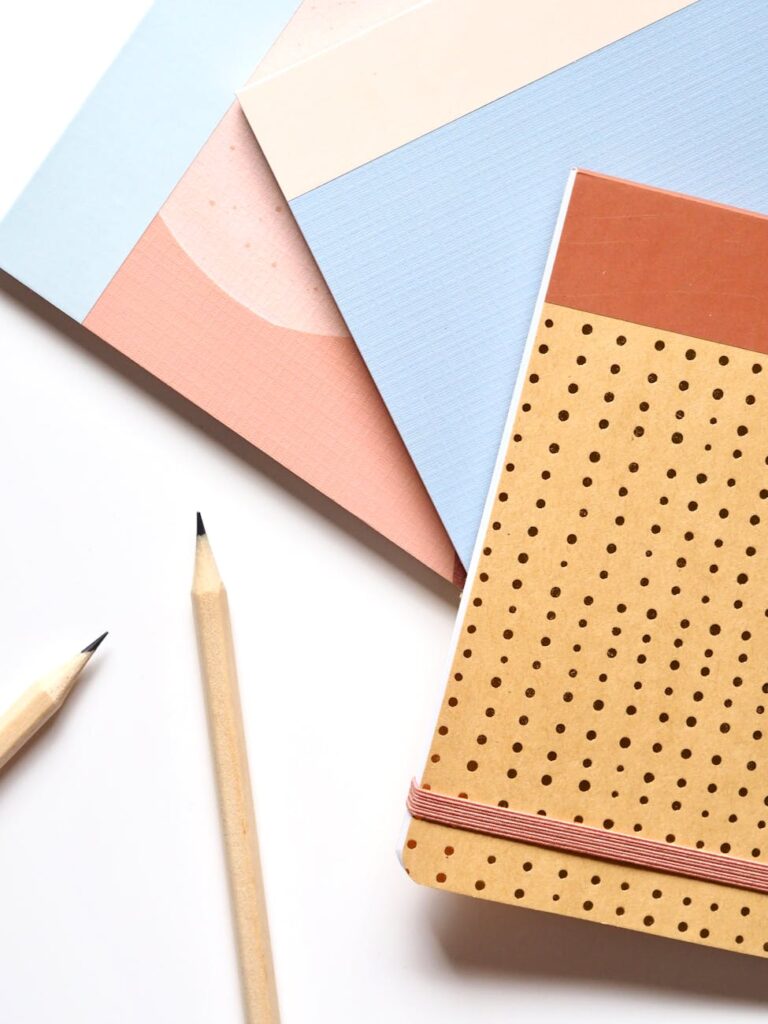 Close-up of a student's hands organizing their weekly planner next to a cup of coffee.
