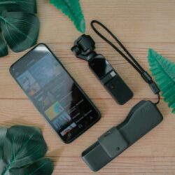 A focused college student sitting in a library, using a money-saving app on their smartphone to track expenses.
