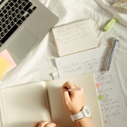 A university student's desk with a neatly organized notebook showing the Cornell method of note-taking.