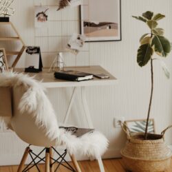 A focused student organizes their weekly schedule in a planner next to an open laptop.