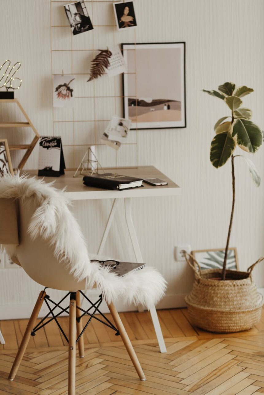 A focused student organizes their weekly schedule in a planner next to an open laptop.