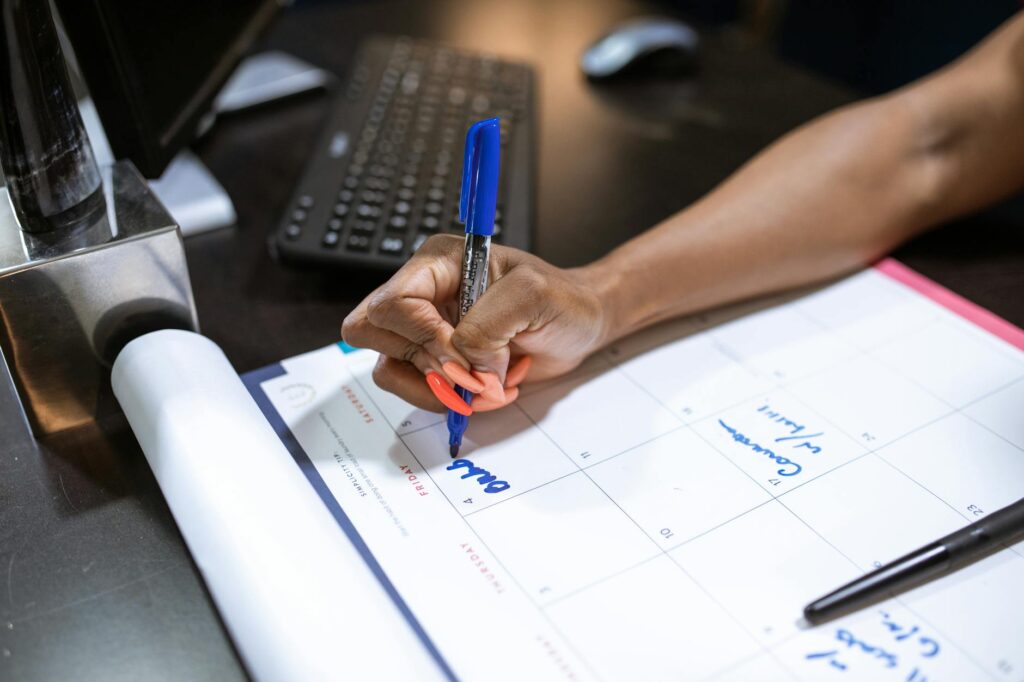 A clean, organized desk with a weekly planner, color-coded notes, and a cup of coffee, symbolizing effective time management.