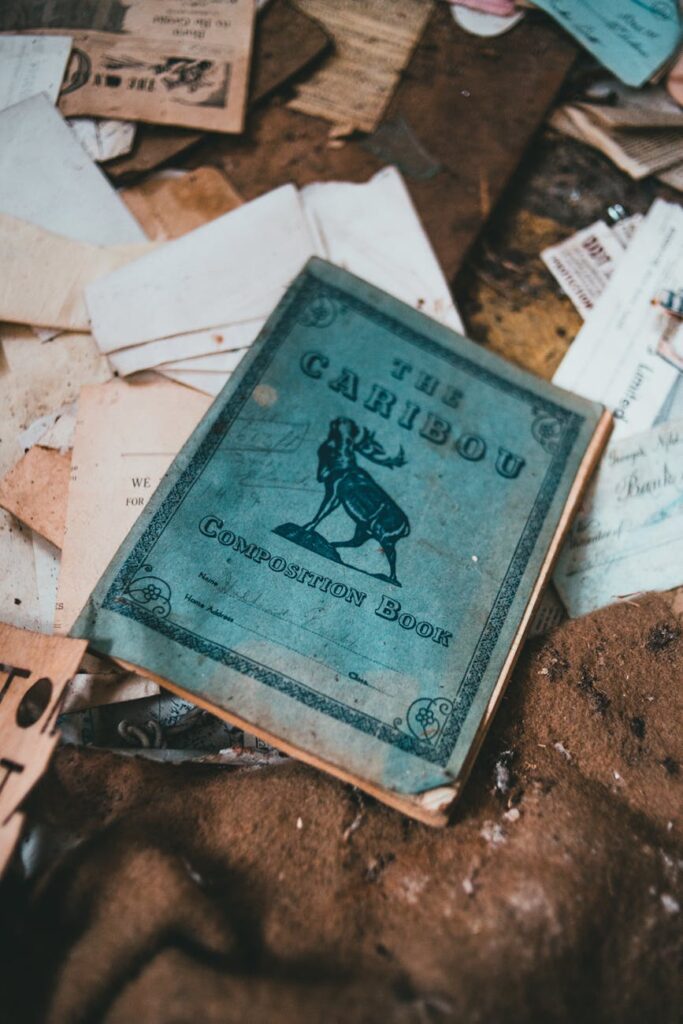 A tired student rests their head on a desk cluttered with open books and papers, feeling overwhelmed.