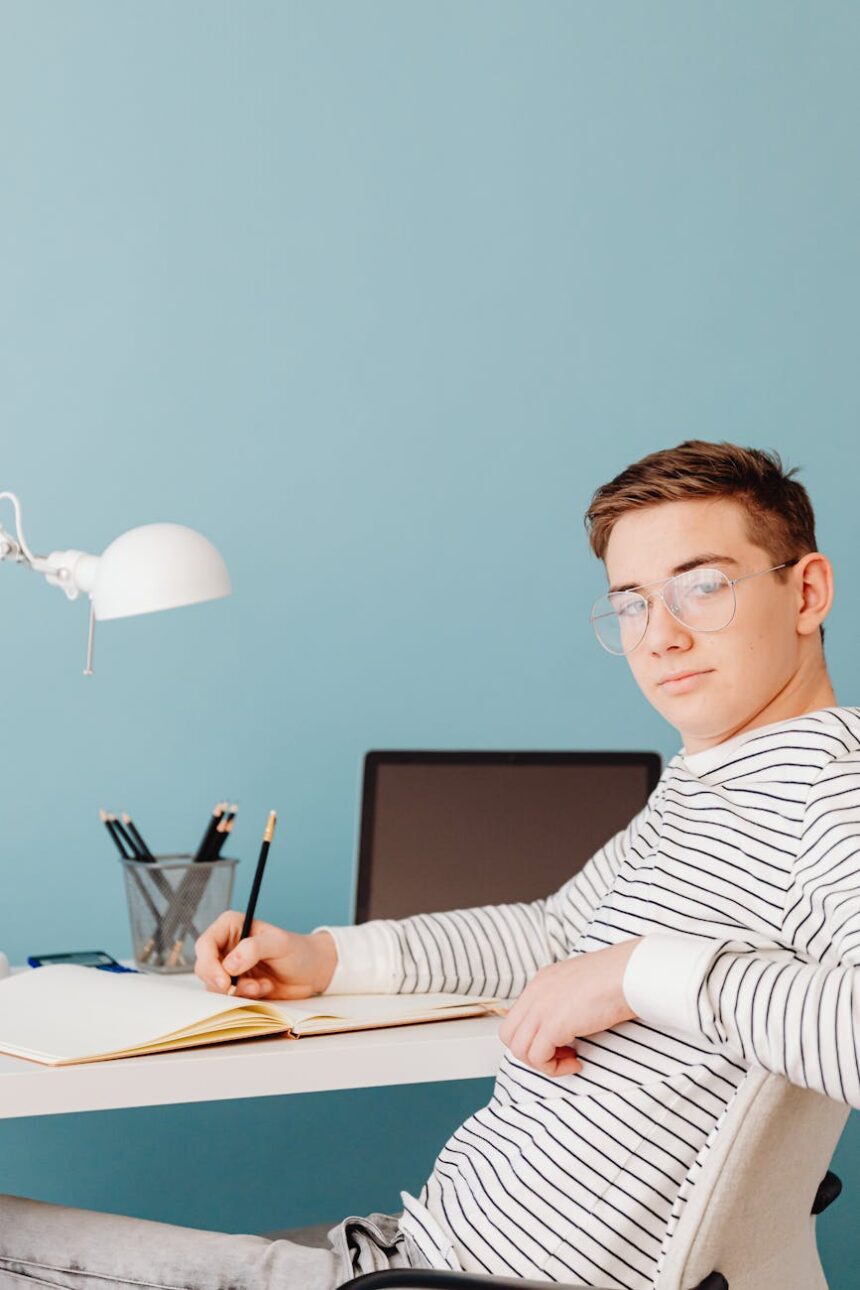 A focused college student carefully crafting their resume on a laptop in a well-lit study area.