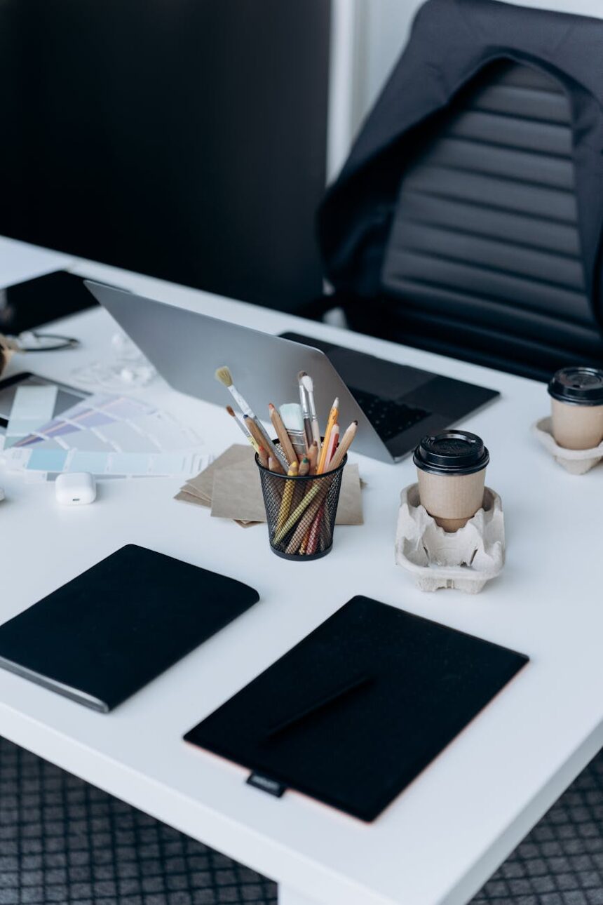 A neat and organized student's desk featuring an open laptop, a spiral notebook, and a cup of coffee.