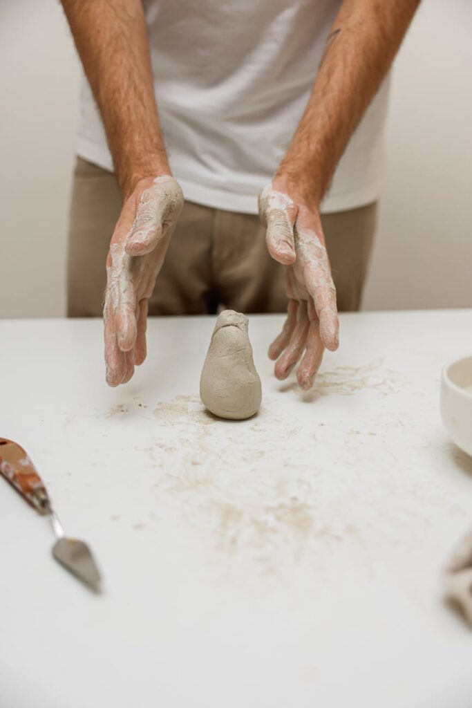 A potter's hands carefully shaping clay on a wheel, representing a hands-on, passionate skill.