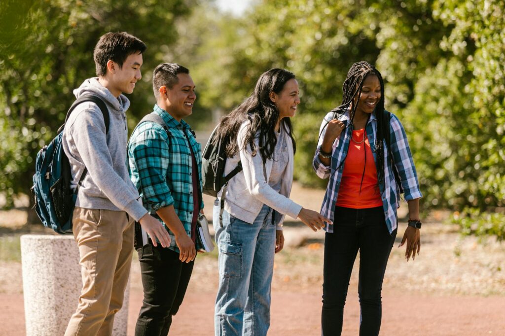 A diverse group of college students collaborating on a project around a table in a campus common area.