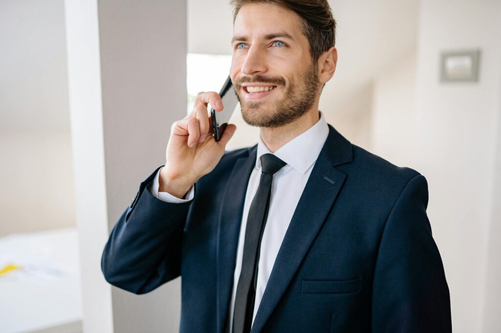 A recent graduate, dressed professionally, smiles confidently in a modern office, ready for her first job.
