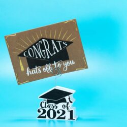 A young college student smiling while using a credit card to pay for coffee.