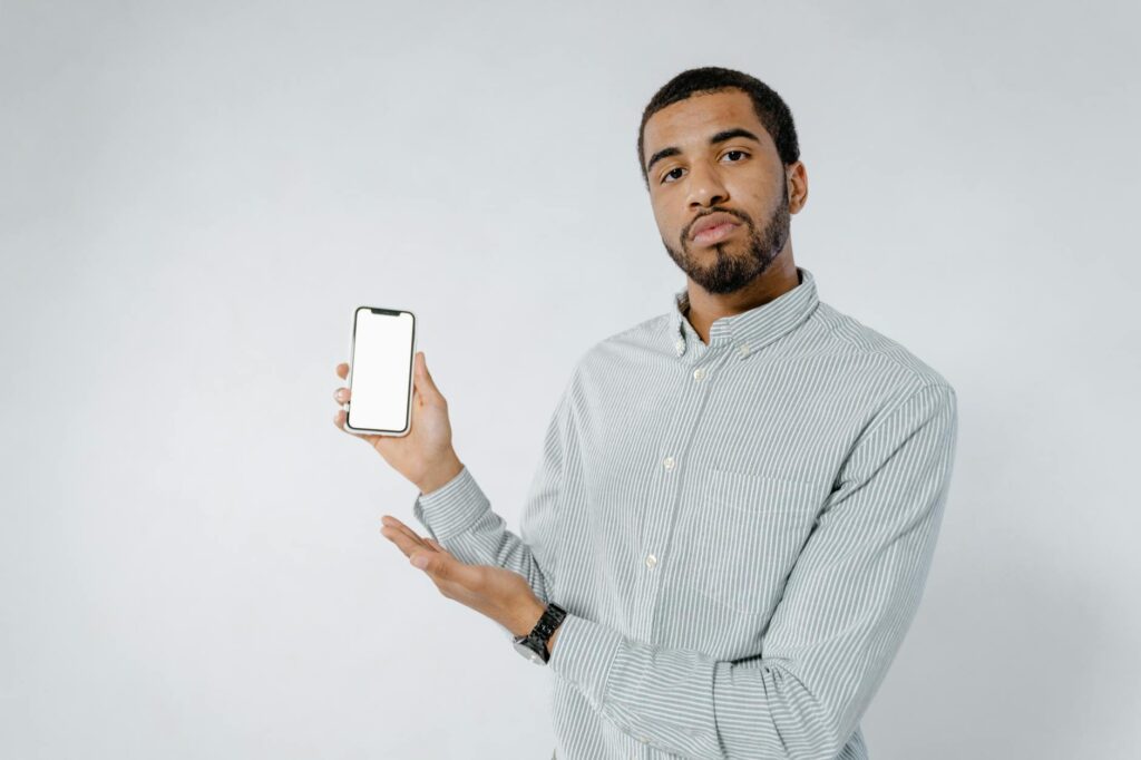 Close-up of a hand holding a smartphone with a student discount app open, ready to get a deal.