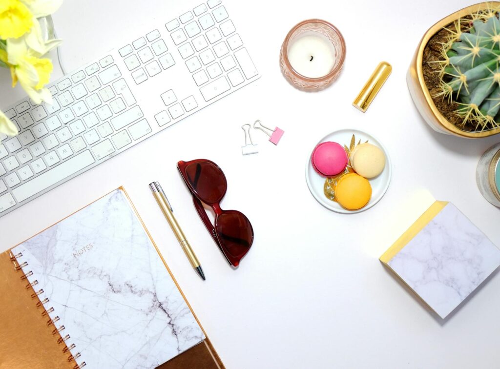 An overhead view of a neat and organized student desk, featuring an open planner, a laptop, and color-coded notes.